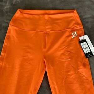 PELOTON
Cadent High Rise Pocket Legging
Size L
Tangerine
